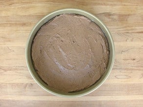 Cake batter poured into round cake pan.