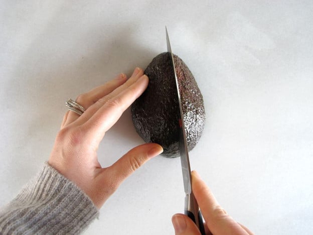 Quartering an avocado.