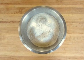Flour and other dry ingredients sifted into a mixing bowl.