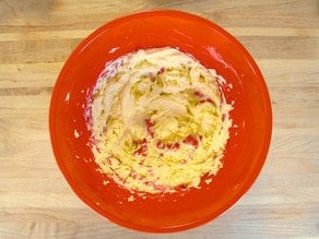 Beating butter in a large mixing bowl.