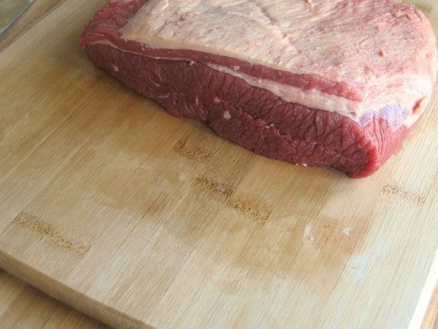 Trimming fat from beef brisket.