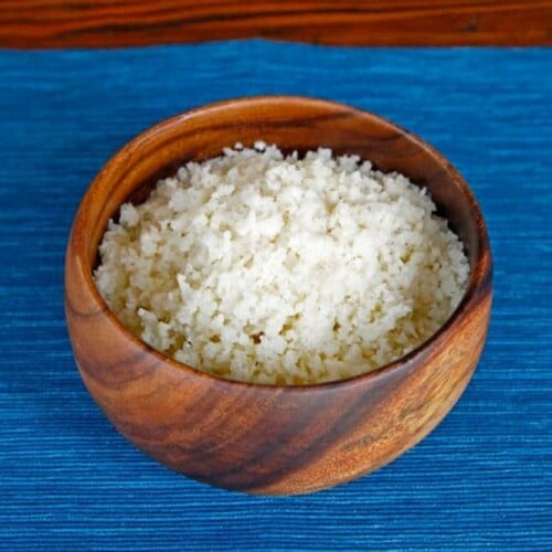 A bowl of shredded cauliflower to make homemade Cauliflower Couscous