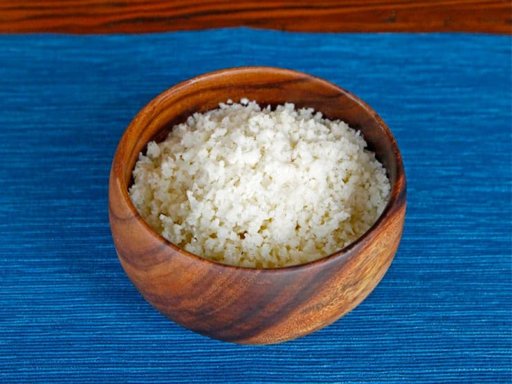 A bowl of shredded cauliflower to make homemade Cauliflower Couscous