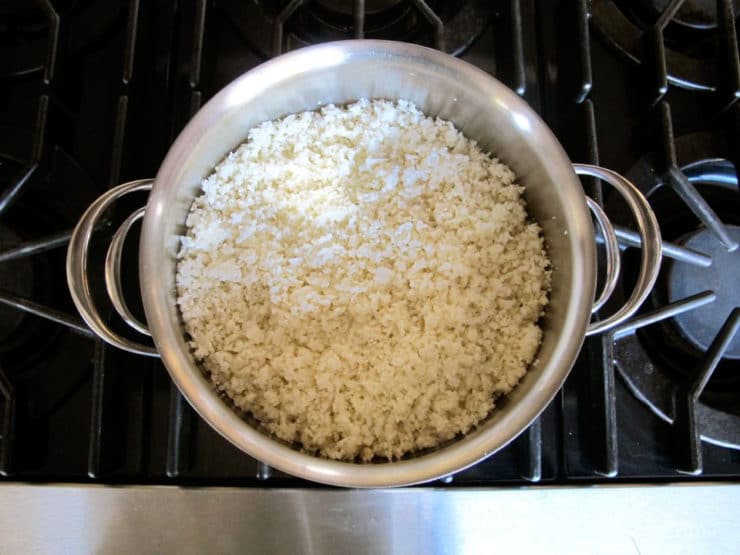Boiling riced cauliflower on the stove.