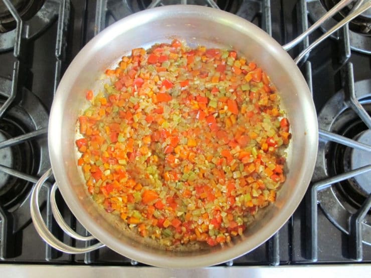 Sauteeing diced vegetables in a large saucepan.