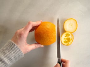 Slicing the ends off an orange.
