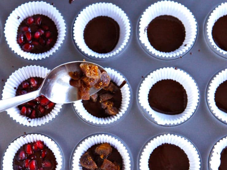 Adding chopped dates to chocolate fruit candies in muffin liners.