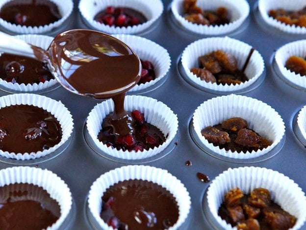 Covering fruit with melted chocolate.
