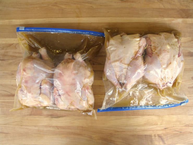 Cornish hens marinating in bags.