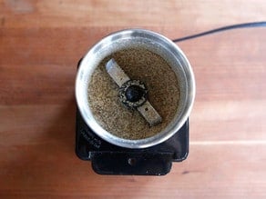 Grinding chia seeds in a spice grinder.