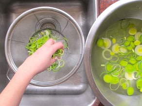 Straining leeks from water.