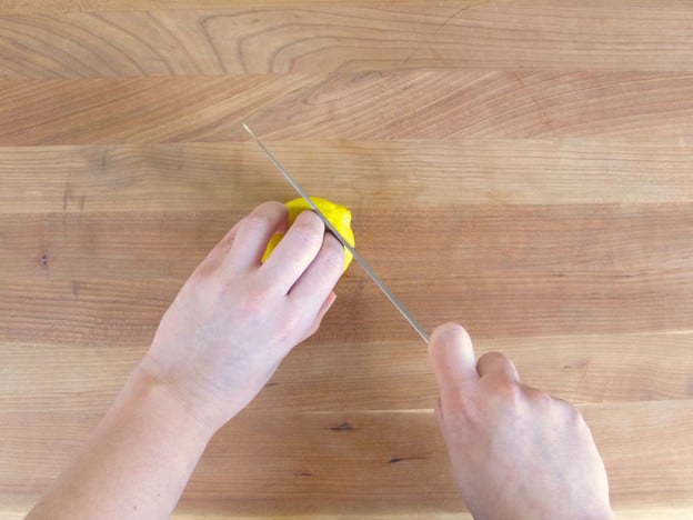 Slicing the ends off lemons.