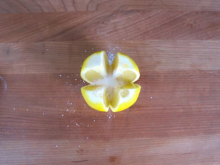 Salting the inside of lemons.