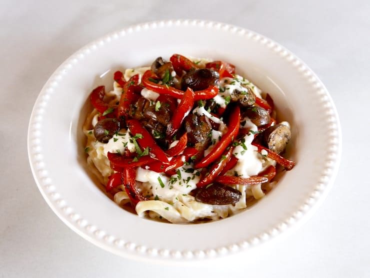 A delicious dish featuring sautéed mushrooms and peppers tossed with pasta