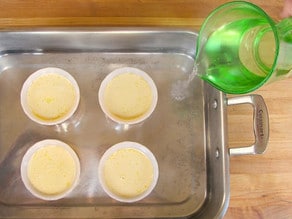 Setting up a water bath for custard cups.