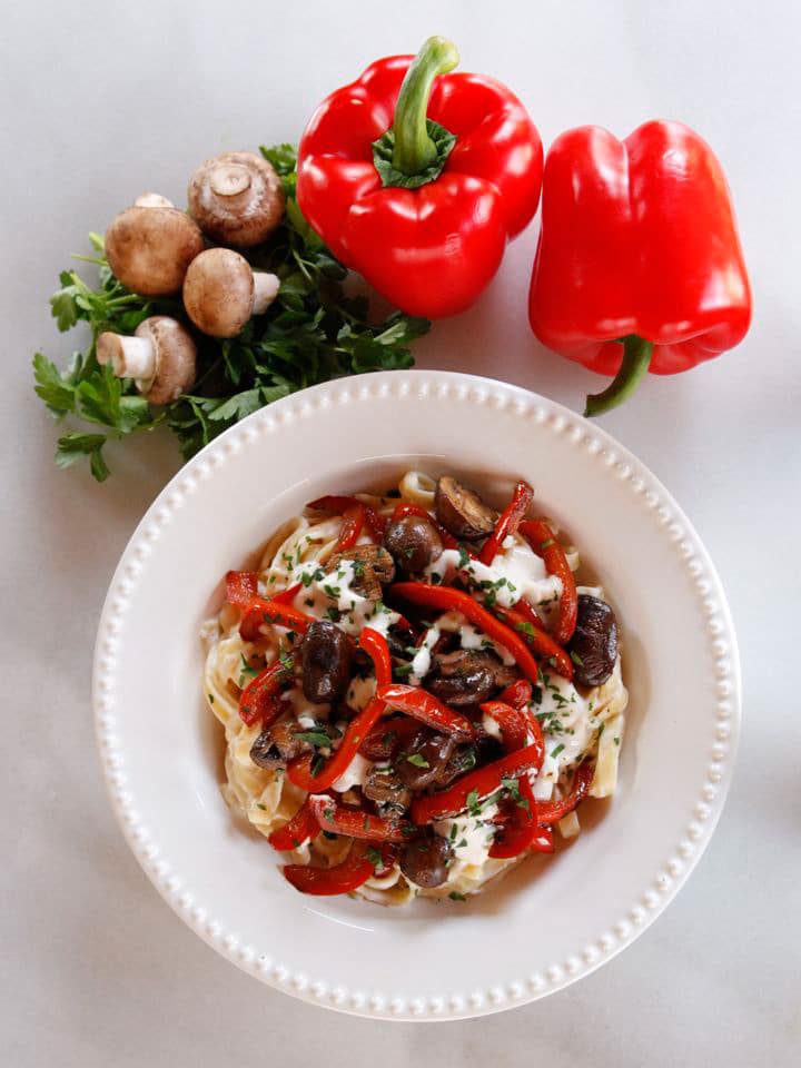 Mushroom Pepper Pasta with Feta Goat Cheese Sauce - Recipe for fettuccine pasta tossed with a creamy feta goat cheese sauce, topped with seared mushrooms and bell peppers. Flavorful, easy weeknight meal.