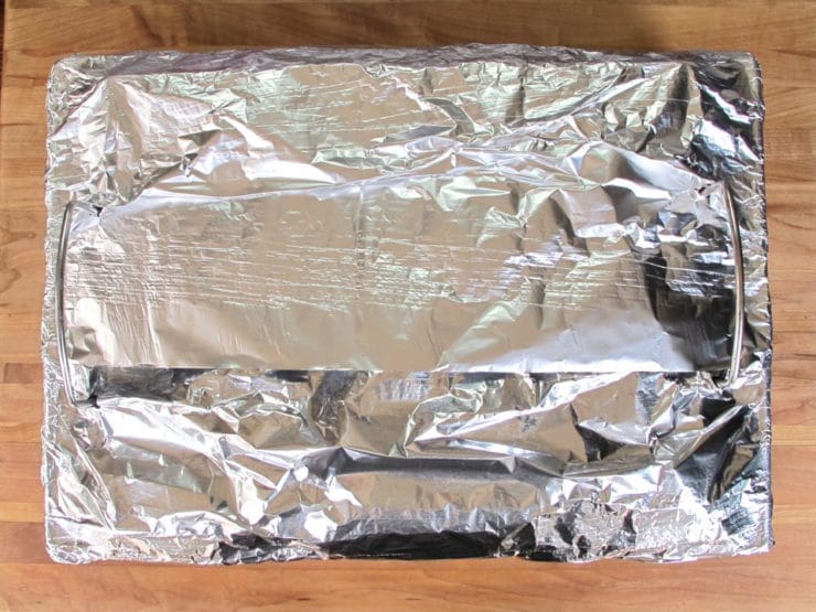 Brisket in roasting pan covered in heavy foil.