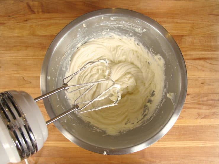 Creaming sugar into cream cheese.