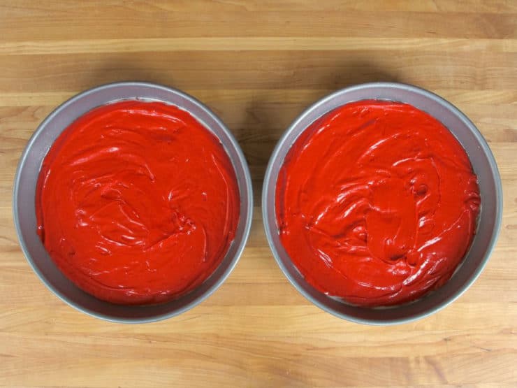 Cake batter divided into two round pans.