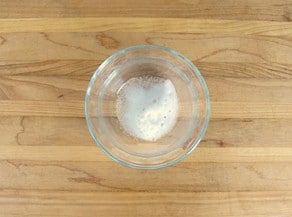 Combining baking soda and vinegar in a small bowl.