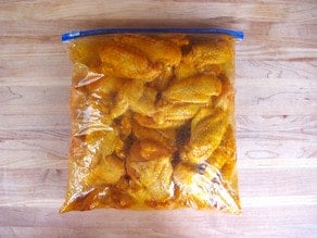 Chicken wings marinating in a bag.