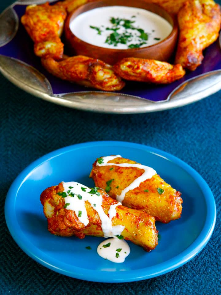 Spicy Middle Eastern Chicken Wings with Creamy Tahini Sauce - Baked, not fried. Lightened up, flavorful alternative to buffalo wings.