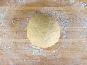 Dough ball turned out onto a lightly floured surface.