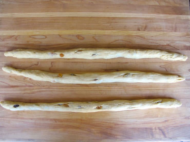 Bread dough in three even logs.