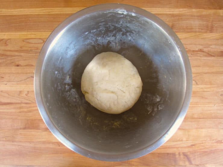 Pie crust dough in a ball in a mixing bowl.