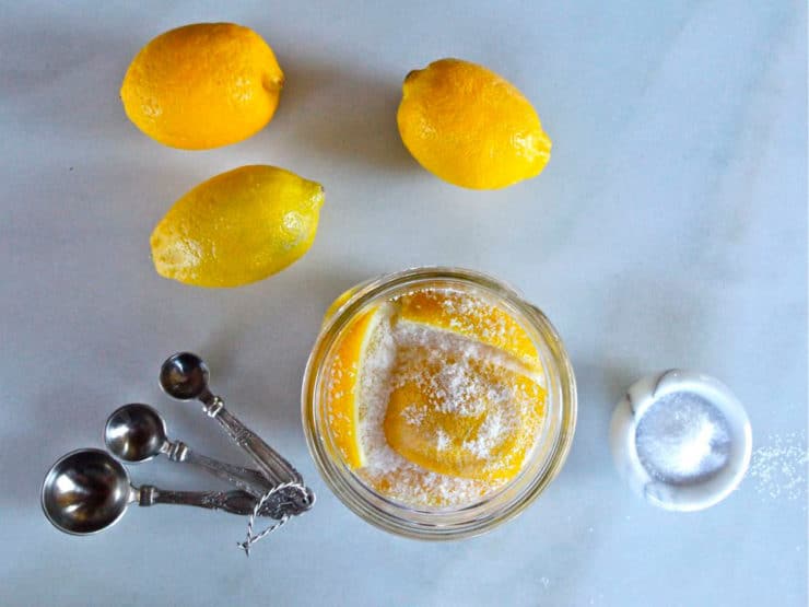 Packing lemon slices in a jar.