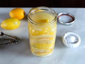 Topping off a jar with fresh lemon juice.