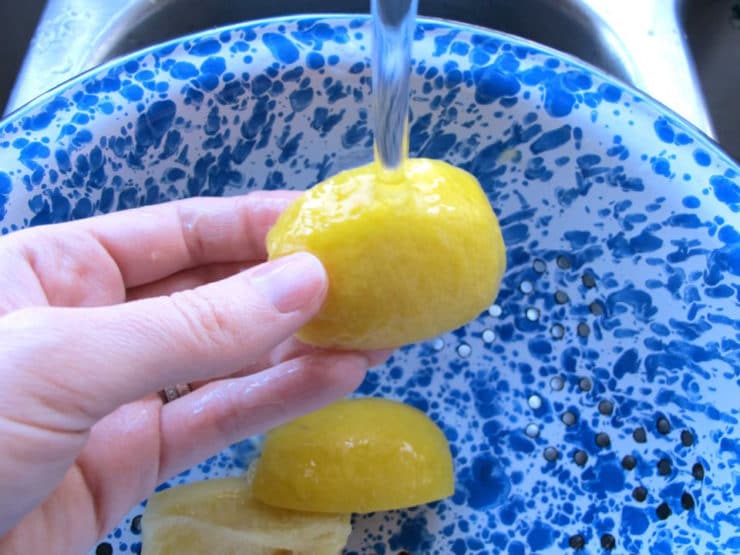 Rinsing salt off a preserved lemon.