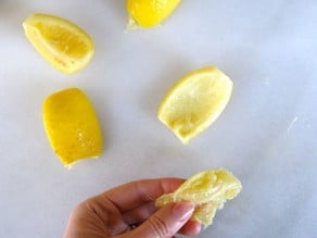 Removing the flesh from preserved lemons.