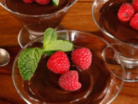 Rich vegan dark chocolate mousse served with raspberries and mint