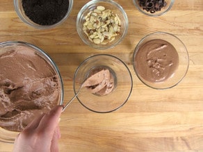 Adding chocolate cheesecake mixture to parfait cups.