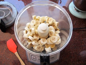 Frozen, sliced bananas in a food processor.