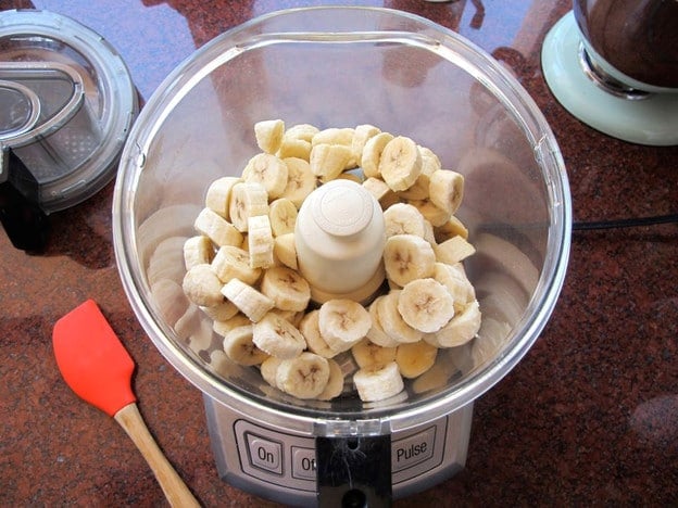 Frozen, sliced bananas in a food processor.