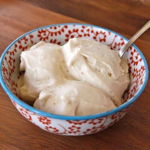 Banana Soft Serve ice cream with spoon served on a colorful bowl on top of a table