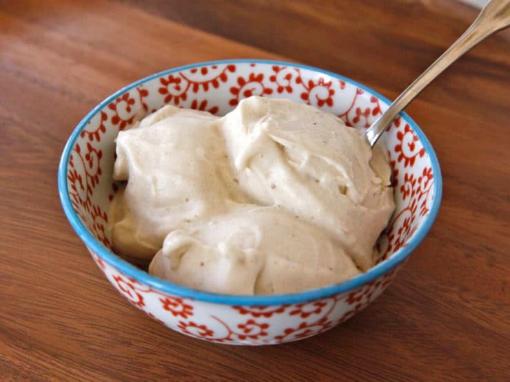 Banana Soft Serve ice cream with spoon served on a colorful bowl on top of a table