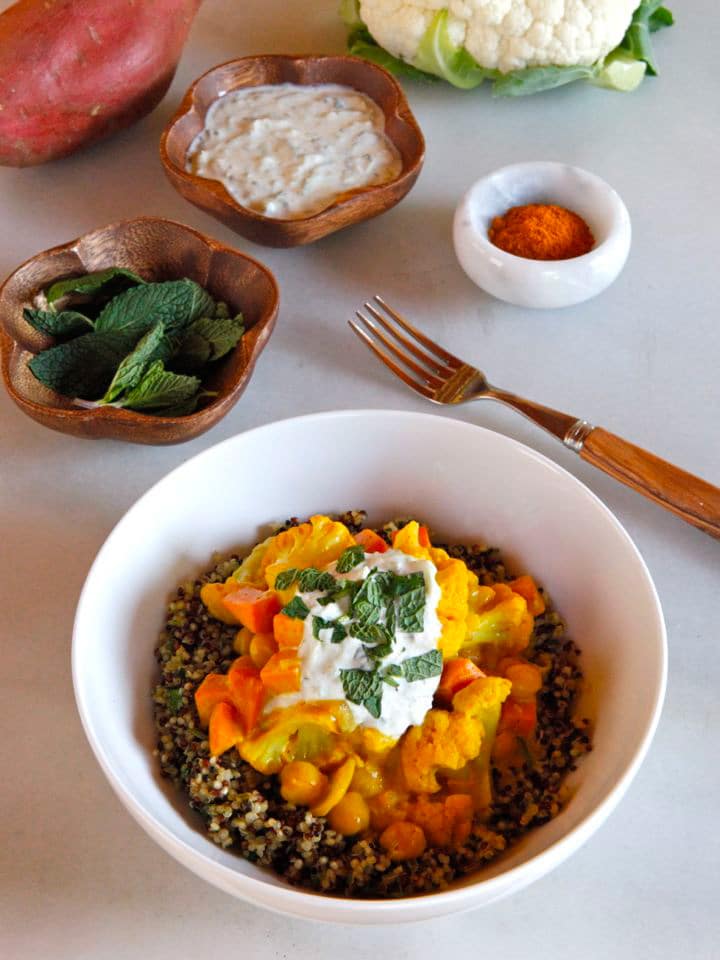 Vegetable Curry Quinoa Bowl - Recipe for creamy Indian-Style curry with cauliflower, sweet potato and chickpeas, over mint and parsley quinoa. Vegan or Vegetarian.