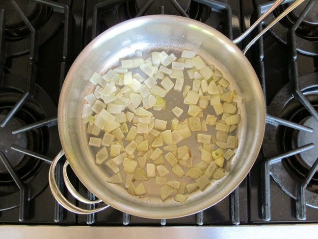 Sauteeing onions in a saucepan.