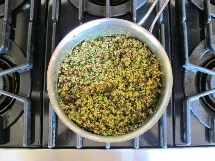 Herbs stirred into cooked quinoa.