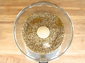 Toasted sunflower seeds in a food processor.