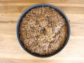 Round cake pan topped with streusel.