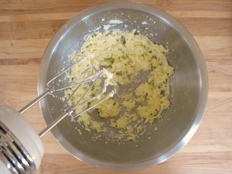 Creaming butter and sugar in a mixing bowl.