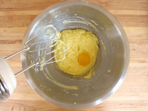 Beating eggs into cake batter.