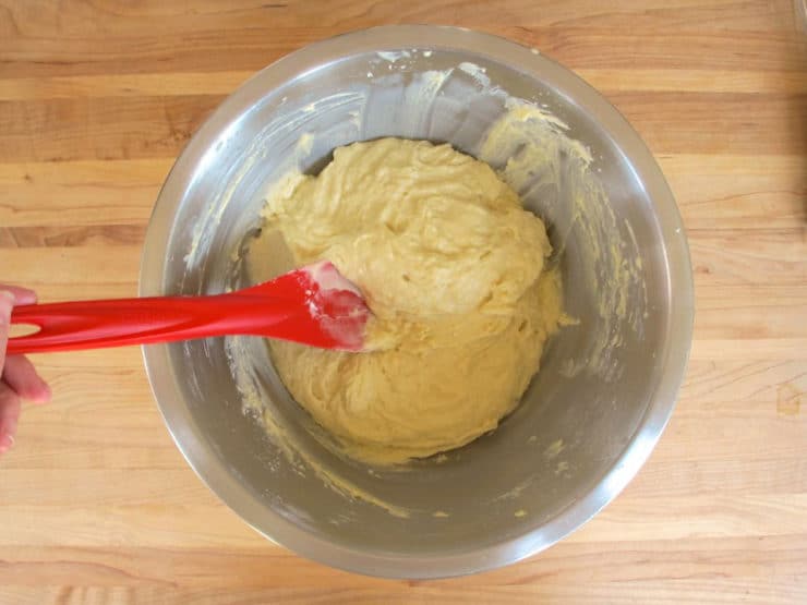 Adding dry ingredients to wet cake batter.
