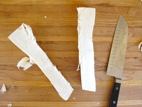 Cutting horseradish to fit in food processor tube.