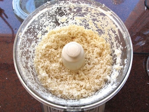 Wet ingredients added to horseradish in food processor.