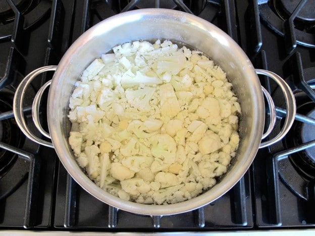 Chopped cauliflower in a stockpot.